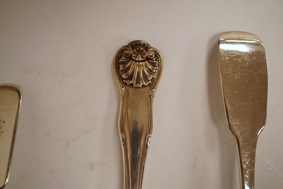 A George III silver fiddle pattern stilton scoop, John Lias, London, 1816, 20cm, together with two Georgian silver sauce ladles, a similar sifter ladle and a William IV shell pattern fish knife, 8.9oz.